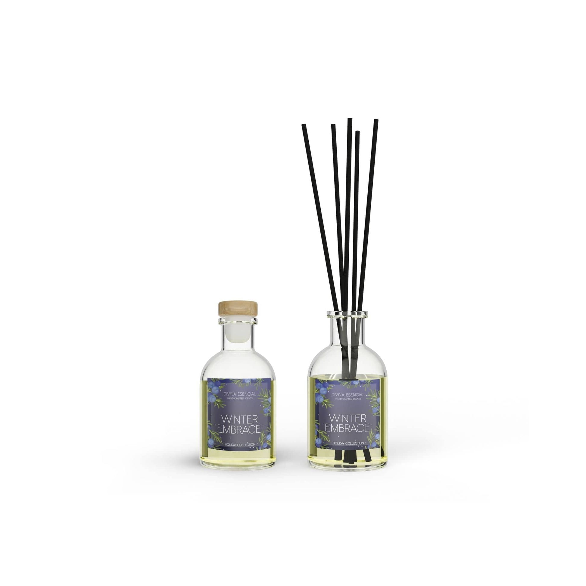 Two bottles labeled 'Winter Embrace' with diffuser sticks on a white background