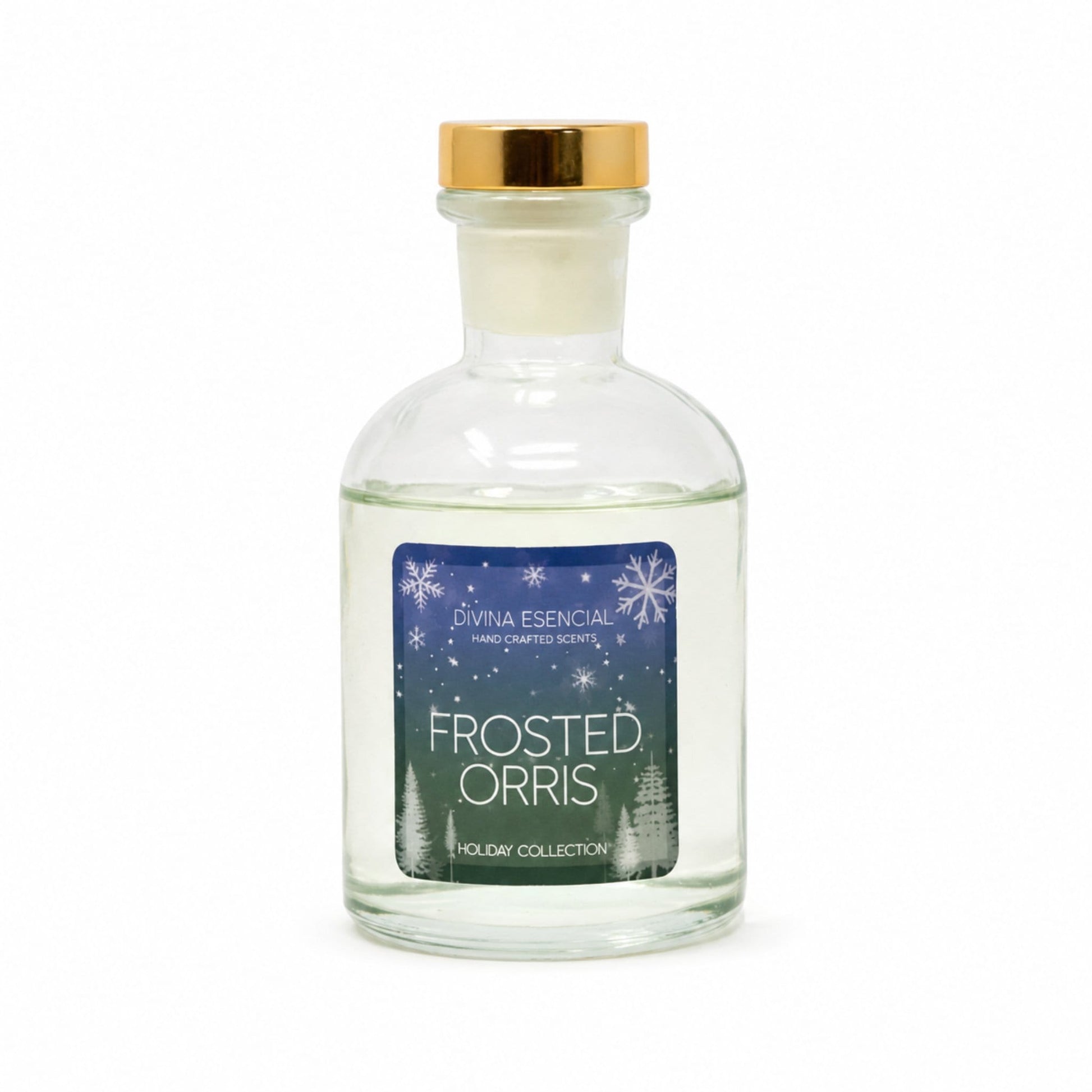 A clear glass bottle of Livna Essential handcrafted scents 'Frosted Orris' with a gold cap and a blue winter-themed label, set against a plain white background.