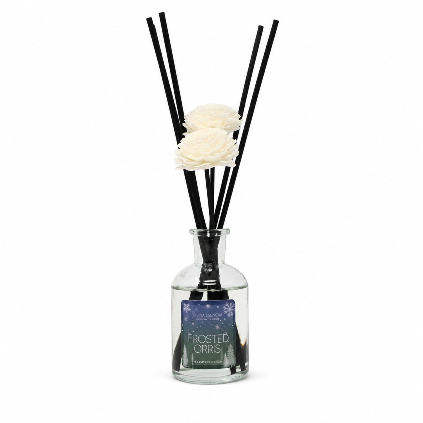 A reed diffuser bottle with a clear glass body, black reeds, and two white artificial flowers, with a label reading 'FROSTED ORRIS'.