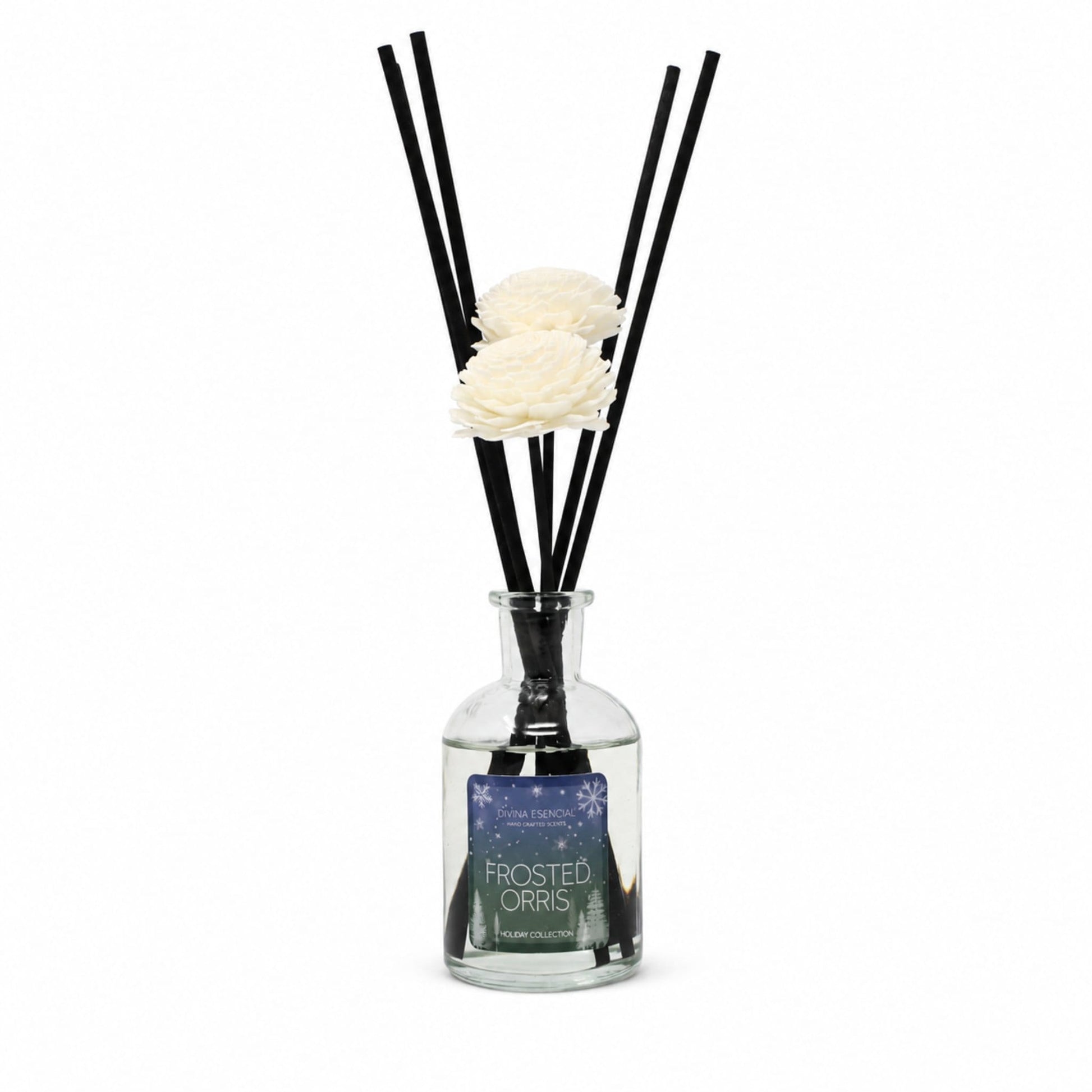 A reed diffuser bottle with a clear glass body, black reeds, and two white artificial flowers, with a label reading 'FROSTED ORRIS'.