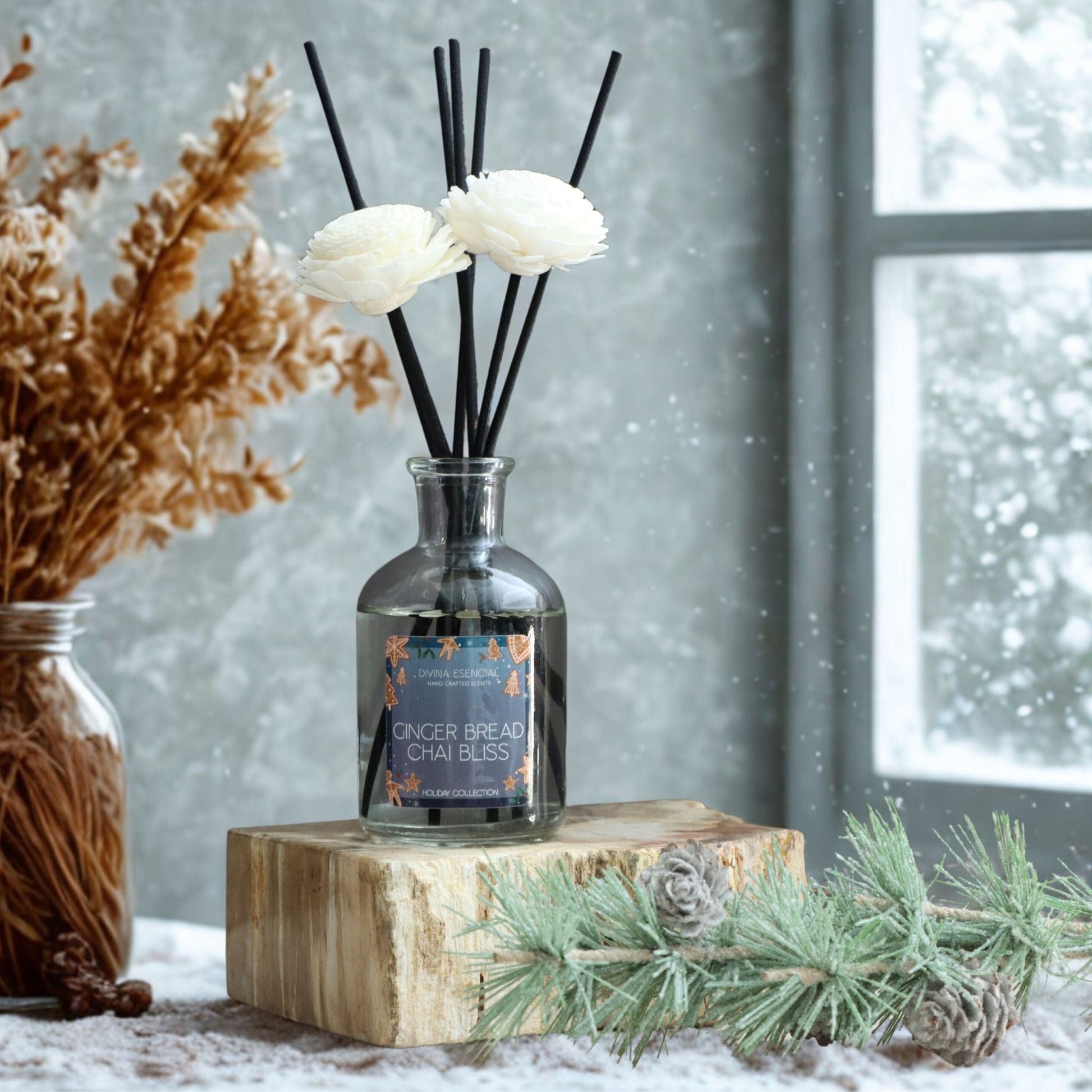 Diffuser with floral reeds on a wooden block in a snowy setting