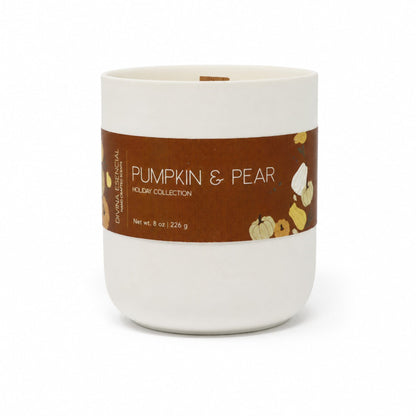 A white ceramic candle jar with a brown paper label reading 'Pumpkin & Pear Holiday Collection' on a clean white background.