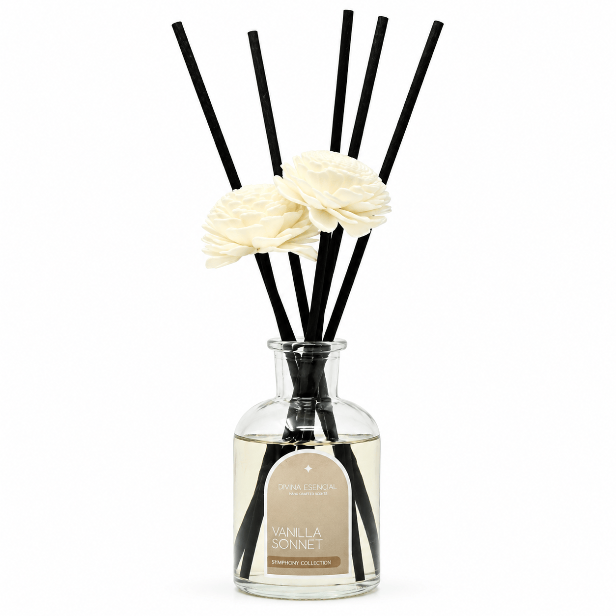 Diffuser with black sticks and white flowers in a clear bottle on a white background